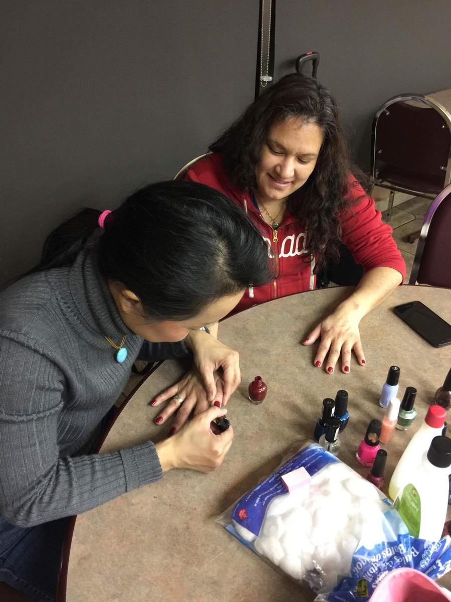 Volunteer, Catherine Yeung offers support and manicures at Beauty Night